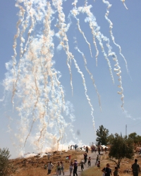 Tear gas canisters fired by Israeli forces during a weekly demonstration in Bil'in